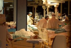 FILE - Medical personnel attend patients at Casalpalocco Covid 3 hospital in the outskirts of Rome, Jan. 1, 2021.