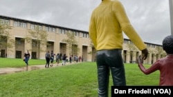 Students walking past an art installation at Carnegie Mellon University.