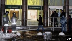 Police stand at the entrance of a supermarket, after an explosion in St. Petersburg, Russia, Dec. 27, 2017. 
