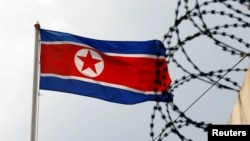 The North Korea flag flutters next to concertina wire at the North Korean embassy in Kuala Lumpur, Malaysia.