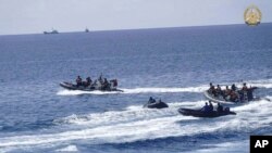 FILE - Philippine navy personnel collect remains of food packs floating in the South China Sea, May 19, 2024. The Philippines said the Chinese coast guard seized another food pack dropped by a plane for Filipino navy personnel. The nations are in an ongoing struggle over the sea.