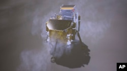 In this image provided on Jan. 3, 2019, by China's Xinhua News Agency, a simulated landing process of Chang'e-4 lunar probe is seen through the monitor at Beijing Aerospace Control Center in Beijing. A Chinese spacecraft on Thursday, Jan. 3, 2019, made th
