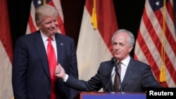 FILE - Then-Republican presidential candidate Donald Trump listens as Senator Bob Corker of Tennessee speaks at a campaign rally in Raleigh, N.C., July 5, 2016. Corker has drawn Trump's ire for questioning whether the president has the "stability" and "competence" needed to succeed in office.