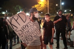 FILE - Demonstrators protests the shooting of Jacob Blake in Kenosha, Wisconsin, Aug. 26, 2020.