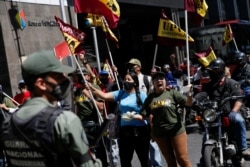 Members of Venezuelan People's Union (UPV) protest outside Venezuela's National Assembly building during the swear-in ceremony for a new term in Caracas, Venezuela, Jan. 5, 2021.