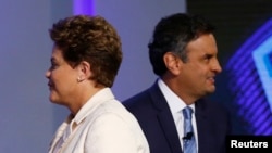 Brazil's presidential candidates Aecio Neves (R) of Brazilian Social Democratic Party (PSDB) and Dilma Rousseff of Workers Party (PT) take part in a TV debate in Rio de Janeiro, Oct. 2, 2014.