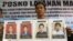 North Sumatra Regional Police spokesperson Col. Raden Heru Prakoso shows the mug shots of four convicted terrorist who were among more than 200 inmates who escaped Tanjung Gusta prison, July 16, 2013.