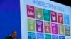 FILE - The 17 goals of the 2030 Agenda for Sustainable Development are seen behind then-U.N. Secretary-General Ban Ki-Moon at the Annual Conference of Swiss Development Cooperation in Zurich, Switzerland, Jan. 22, 2016.