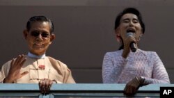 FILE - In this Nov. 9, 2015, photo, Myanmar's pro-democracy icon Aung San Suu Kyi, right, delivers a speech as close ally Tin Oo waves in Yangon, Myanmar. Tin Oo died June 1, 2024, at the age of 97.
