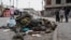 People look at military uniforms and equipment abandoned in the streets of Goma amid conflict between M23 rebels and the Congolese army in Goma, Democratic Republic of the Congo, on Jan. 29, 2025.