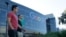 FILE - Two men walk past a building on the Google campus in Mountain View, California. 