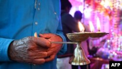 FILE - A Hindu pilgrim prays at Nunwan Pahalgam base camp, 110 kilometers southeast of Srinagar, July 26, 2019, during a pilgrimage to the Hindu holy cave of Amarnath. 