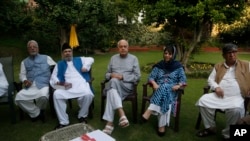 Former Jammu and Kashmir Chief Minister Mehbooba Mufti, second right, National Conference president Farooq Abdullah, center, and other leaders sit during an all parties meeting in Srinagar, India, Aug. 4, 2019. 