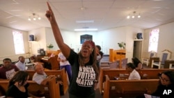 In this Aug. 22, 2018, photo Black Voters Matter co-founder LaTosha Brown speaks at a church as part of The South Is Rising Tour 2018 in Warner Robins, Ga.