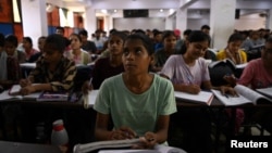 Students attend a class at Super Climax Academy, a coaching institute training students to prepare for competitive examinations to secure government jobs, in Prayagraj, India, June 21, 2024.