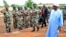 Mali's President Ibrahim Boubacar Keita, right, reviews troops in Kati, near Bamako, after visiting soldiers injured in an attack on their camp in northern Mali earlier in the week that left 11 other soldiers dead, Aug. 6, 2015.