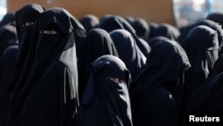 Women stand together al-Hol displacement camp in Hasaka governorate, Syria, April 2, 2019. 