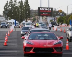 People wait in their vehicles to monitor for adverse reactions to the shot, after being vaccinated at a mass COVID-19 vaccination site outside The Forum in Inglewood, California, January 19, 2021.