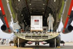 A shipment of 600,000 doses of COVID-19 vaccines donated by China arrives at the Phnom Penh International Airport, Feb. 15, 2021.