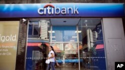 A woman walks by a Citibank branch in Buenos Aires, Argentina, March 17, 2015.