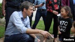 U.S. Rep. Beto O'Rourke, running for the U.S. Senate seat, greets a young supporter following a campaign rally at Texas Southern University in Houston, Texas, Oct. 9, 2018. 