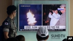 FILE - A South Korean army soldier watches a TV news program showing images published in North Korea's Rodong Sinmun newspaper of North Korea's ballistic missile launch and North Korean leader Kim Jong-un, at Seoul Railway station in Seoul, South Korea, Aug. 25, 2016.