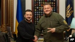 Ukrainian President Volodymyr Zelenskyy, left, shakes hands with General Valerii Zaluzhnyi during their meeting in Kyiv on Feb. 8, 2024, at which Zelenskyy dismissed Zaluzhnyi as the head of Ukraine's armed forces. (Ukrainian Presidential Press Office via AP)
