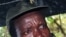 The leader of the Lord's Resistance Army, Joseph Kony, answers journalists' questions following a meeting with UN officials in southern Sudan, Nov 2006 (file photo)