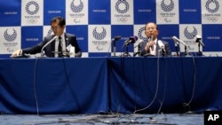 Tokyo 2020 Organizing Committee CEO Toshiro Muto, right, speaks during a news conference after a Tokyo 2020 Executive Board Meeting in Tokyo March 30, 2020. 