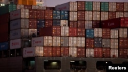 FILE - The YM Bamboo, a container ship operated by the China Ocean Shipping Company, is docked at the Port of Oakland in Oakland, Calif., Jan. 14, 2011. 