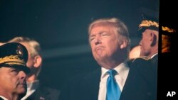 FILE - President-elect Donald Trump, center, listens to a member of the military in Baltimore, Dec. 10, 2016. Plans to put more money into infrastructure and the military may push inflation too high, one central bank leader says.