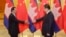 Cambodian Prime Minister Hun Sen (L) shakes hands with China's President Xi Jinping before a meeting at the Great Hall of the People in Beijing, Nov. 7, 2014.