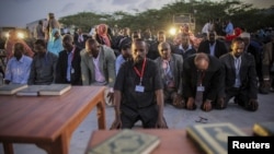 New Somali parliamentarians pray during an inauguration ceremony for members of Somalia's first parliament in 20 years in Mogadishu, August 20, 2012.