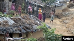 Kate, Duchess of Cambridge carries her son Prince George after his christening at the Chapel Royal in St. James's Palace in London, Oct. 23, 2013.