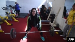In this photo, Afghanistan national power-lifting team member Rasheda Parhiz does an exercise called "dead lift," March 4, 2018. (AFP Photo)