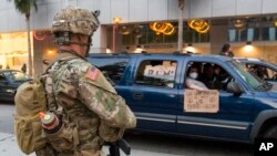 Members of California National Guard patrol, May 31, 2020, in Los Angeles. 