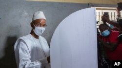 FILE - Guinean opposition leader Cellou Dalein Diallo votes in Conakry, Oct. 18, 2020.