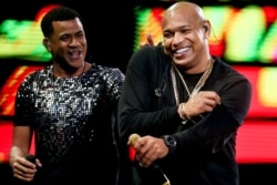 FILE - Randy Malcom Martinez and Alexander Delgado of the Cuban duo Gente de Zona perform in Vina del Mar, Chile, Feb. 22, 2018.