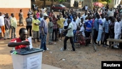 FILE - A man casts his vote at a polling station during a presidential election in Accra, Ghana, Dec. 7, 2012. 