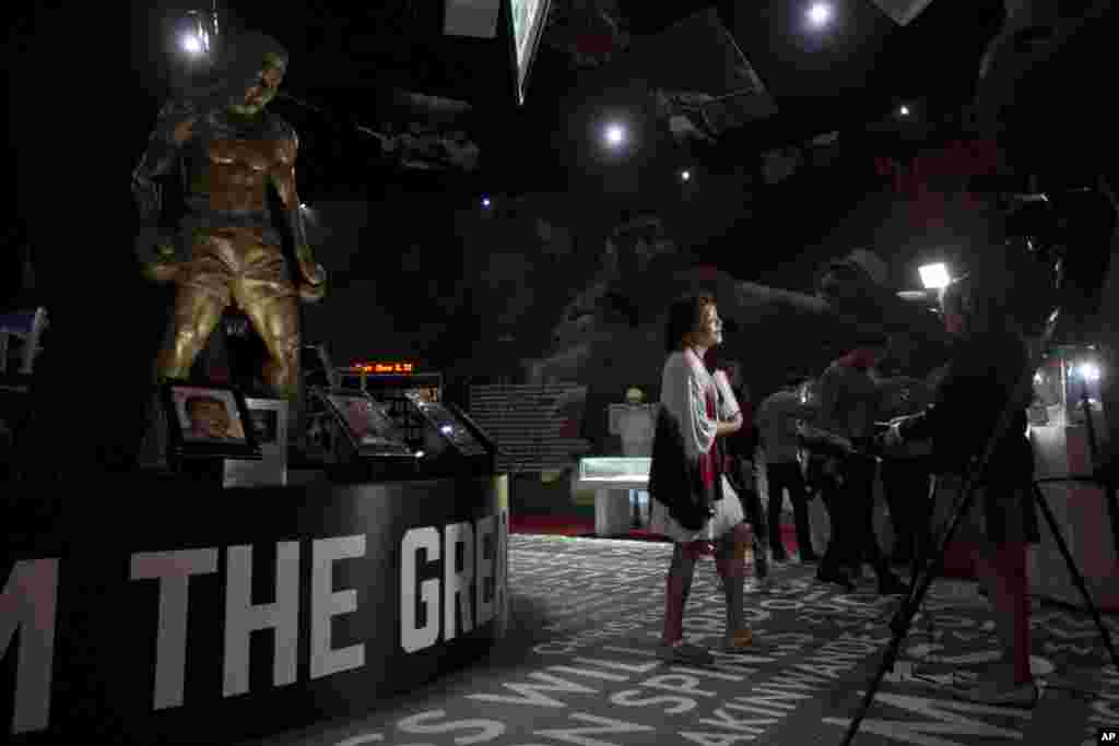 A visitor is interviewed in reaction to the death of heavyweight boxer Muhammad Ali at the "I Am The Greatest, Muhammad Ali" exhibition at the O2 arena, which hosts high profile boxing fights in London, Saturday, June 4, 2016.