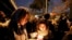 People gather for a candlelight vigil for the victims of the Ukraine plane crash, at the gate of Amri Kabir University that some of the victims of the crash had attended, in Tehran, Iran, Jan. 11, 2020.