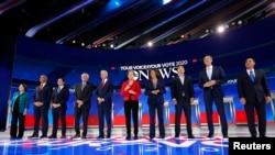 FILE - Democratic U.S. presidential candidates gather on stage before the start at the 2020 Democratic U.S. presidential debate in Houston, Sept. 12, 2019.