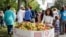 Members of an interfaith group that sponsored Unity Walk 2017 in the U.S. capital prepared apples for marchers in the annual peaceful demonstration for peace and tolerance on Sunday 09/10/17. (B. Bradford/VOA) 