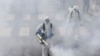 Firefighters disinfect a street against the new coronavirus, in western Tehran, March 13, 2020.