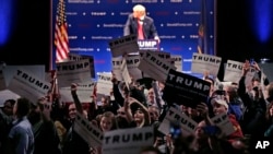 Supporters turn to show their support as a protestor interrupts an address by Republican presidential candidate Donald Trump during a campaign stop at the Flynn Center of the Performing Arts in Burlington, Vt., Jan. 7, 2016.