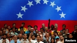 Freddy Guevara, center, first Vice-President of the National Assembly and lawmaker of the Venezuelan coalition of opposition parties (MUD), talks to the media during a news conference in Caracas, Venezuela, July 17, 2017.