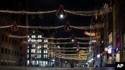 The deserted Damrak street is seen during curfew in the heart of Amsterdam, Jan. 23, 2021. The Netherlands entered its toughest phase of anti-coronavirus restrictions to date, imposing a nationwide curfew from 9 p.m. to 4:30 a.m.