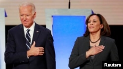 FILE - Former Vice President Joe Biden and U.S. Senator Kamala Harris take the stage before the start of the second night of the second U.S. 2020 presidential Democratic candidates debate in Detroit, Michigan, U.S., July 31, 2019.