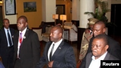 Burundi President Pierre Nkurunziza, center, is escorted on his way to the Julius Nyerere International Airport in Dar es Salaam, Tanzania, May 13, 2015. 