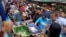 Office workers shop for "iftar," the meal to break their fast on the first day of the holy fasting month of Ramadan, at the main business district in Jakarta, Indonesia, June 18, 2015.